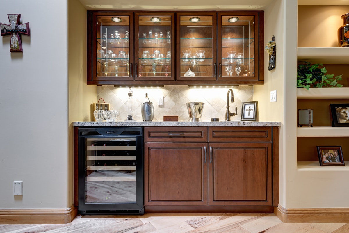 Traditional Style Wet Bar with sink and glass panel insert cabinetry.