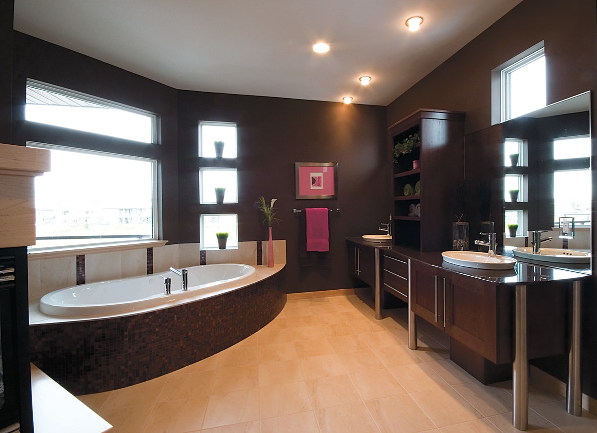 Dark brown walls and vanity with light wood flooring.