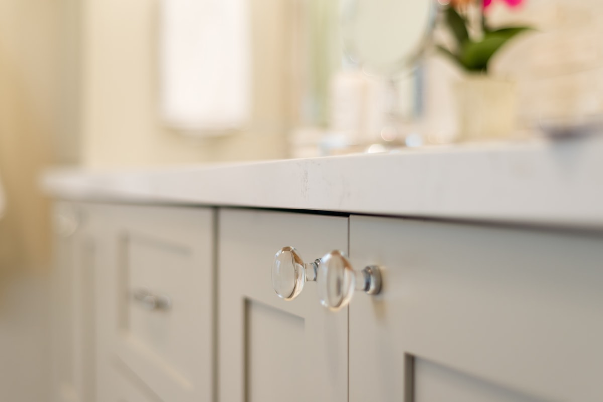 Close-up of a grey vanity with clear hardware.