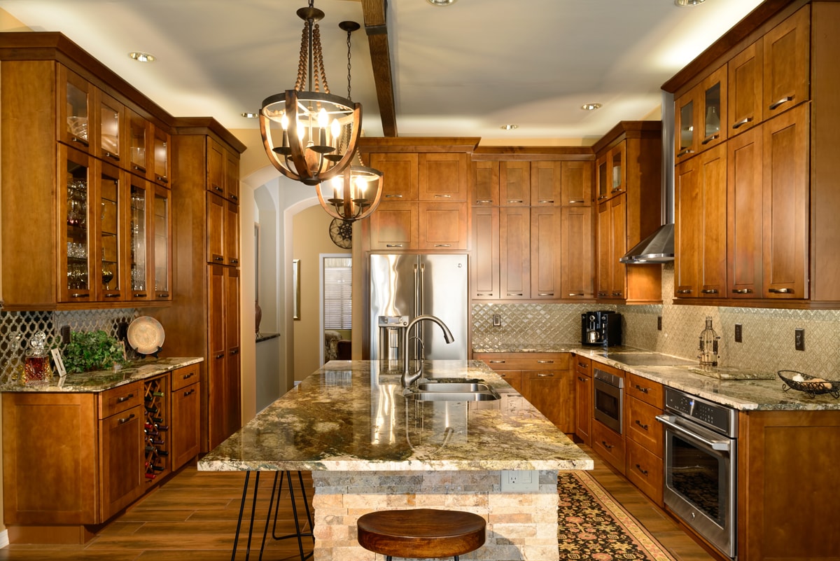 Traditional style kitchen with three walls of warm wood cabinetry.
