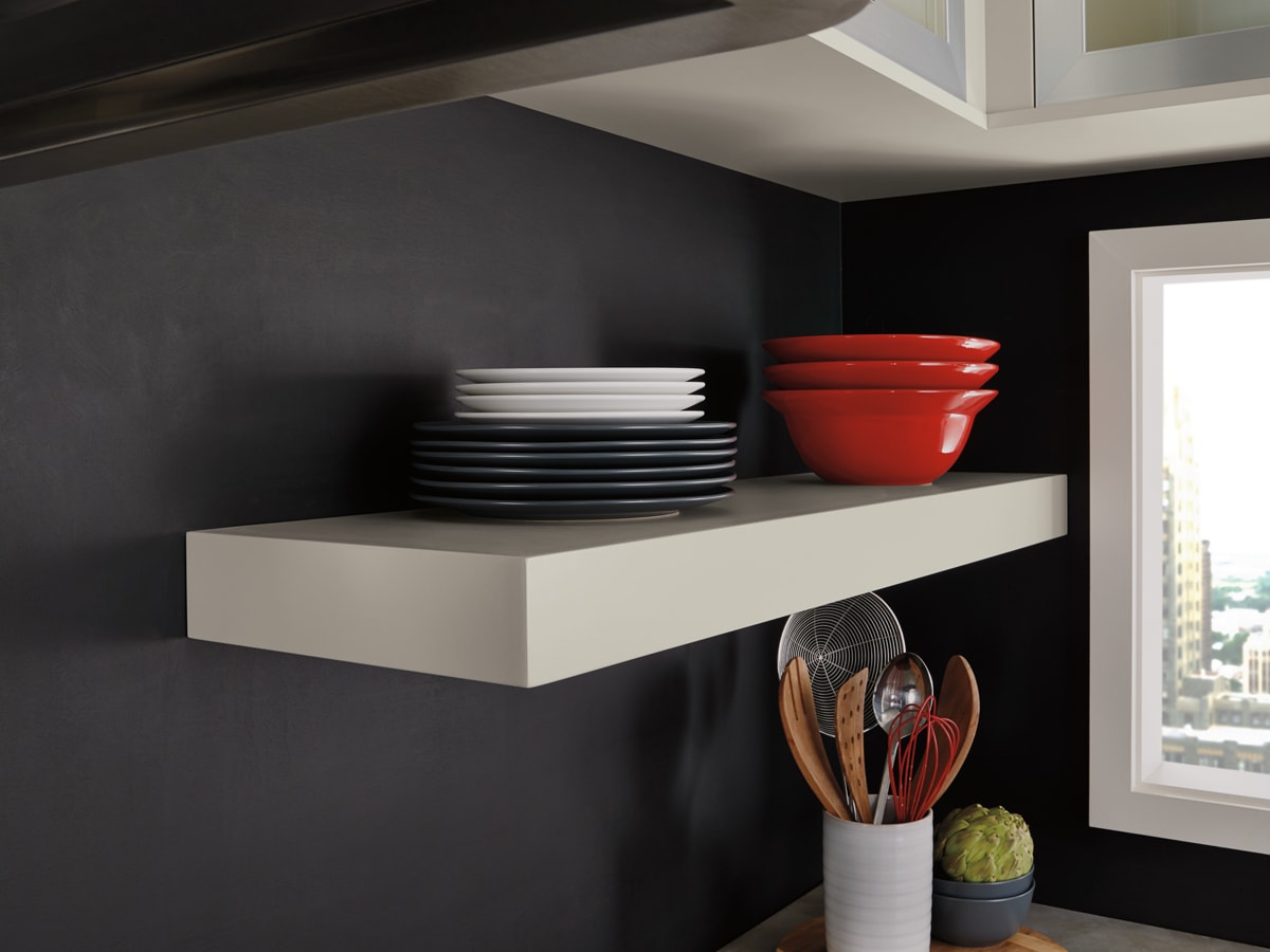 Beige floating shelf with two stacks of plates and bowls.