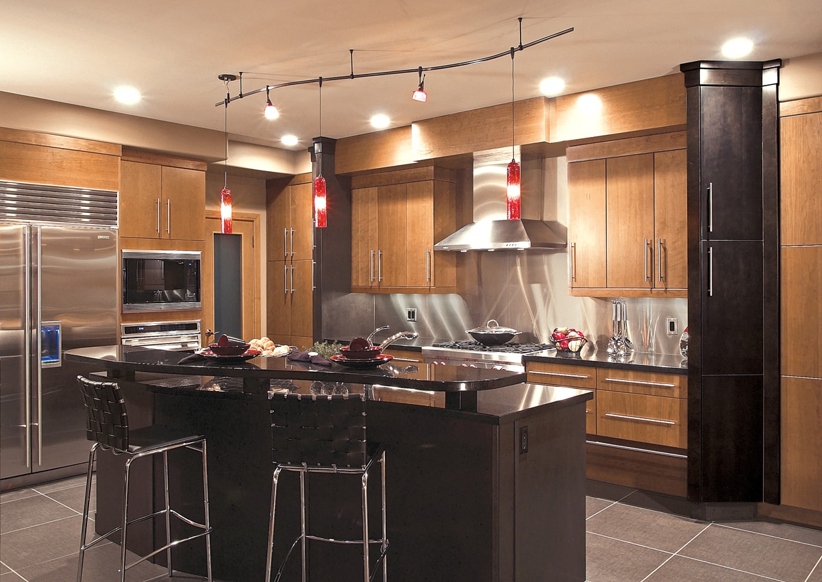 Light and dark warm wood cabinetry with slab style doors.
