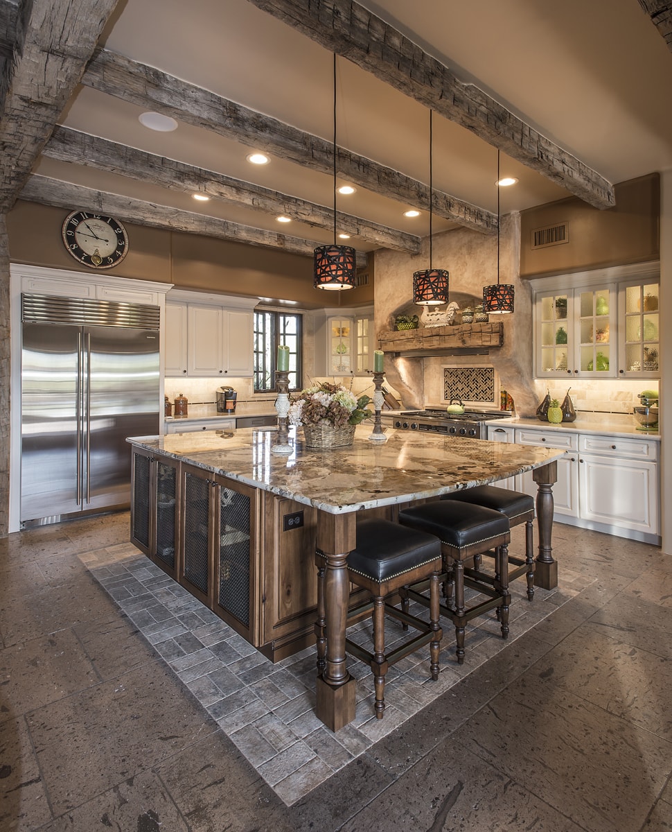 Rustic Traditional style kitchen with a variety of wood and stone textures.
