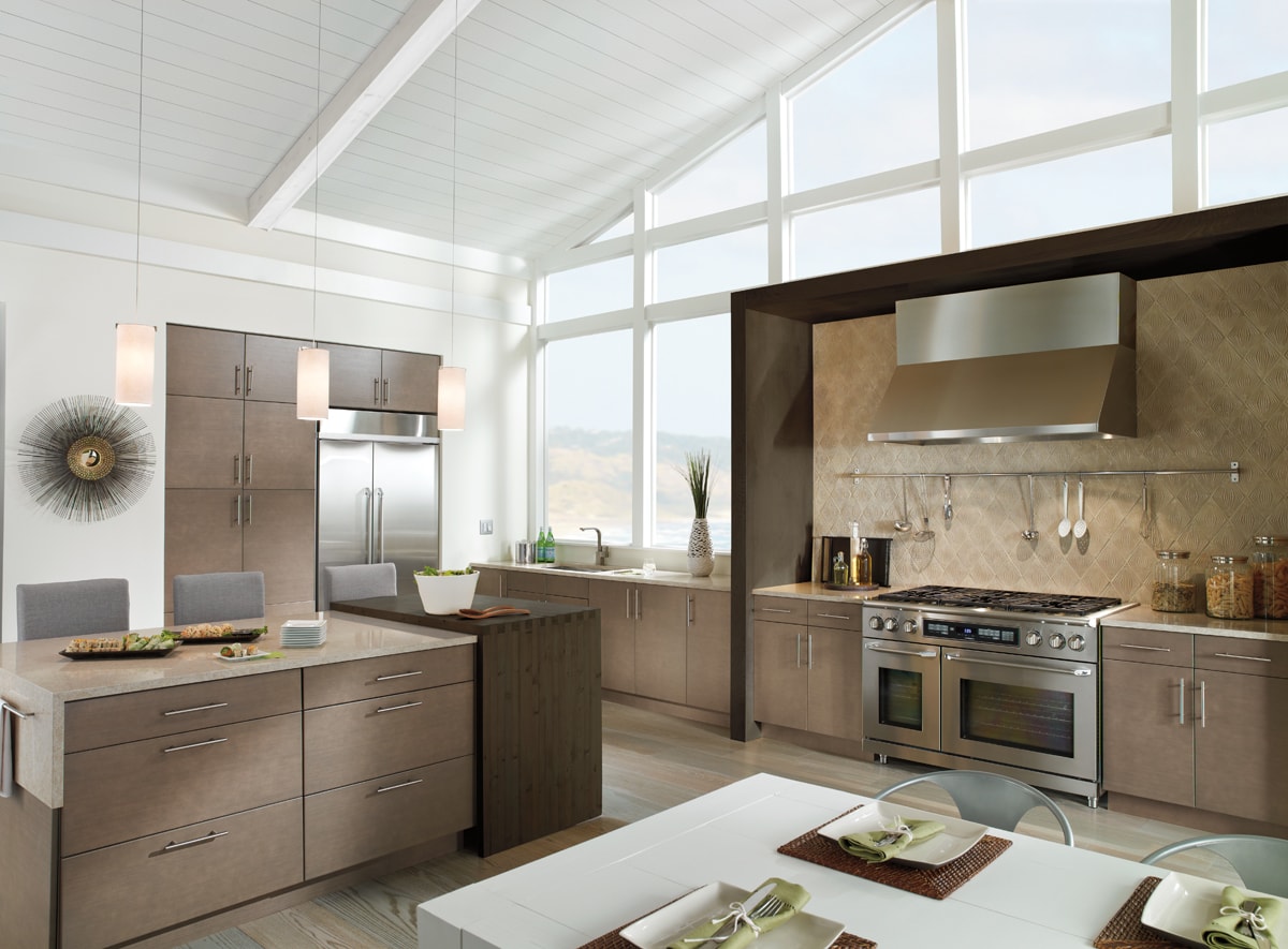 A spacious Contemporary style kitchen with warm neutral cabinets.
