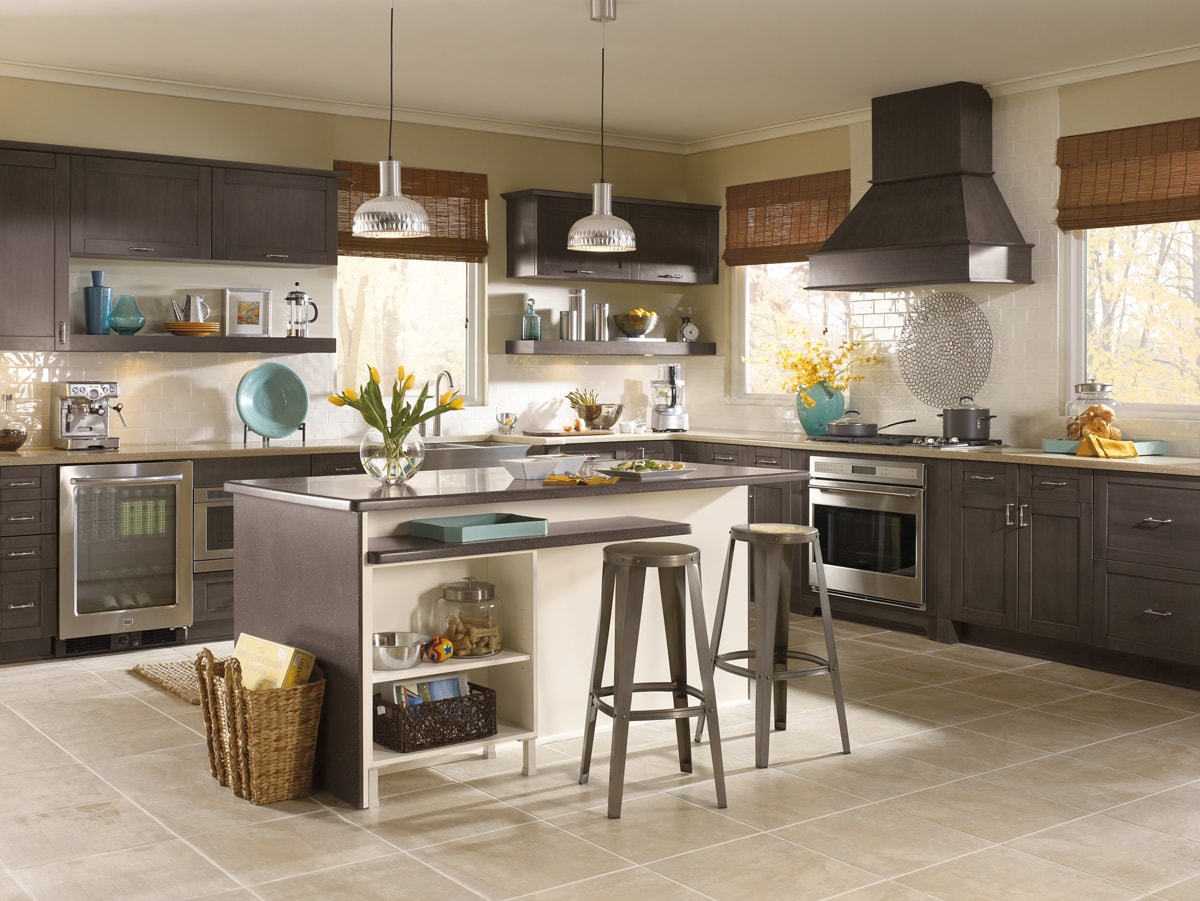 Charcoal colored cabinets in a kitchen with bright accessories and wicker accents.