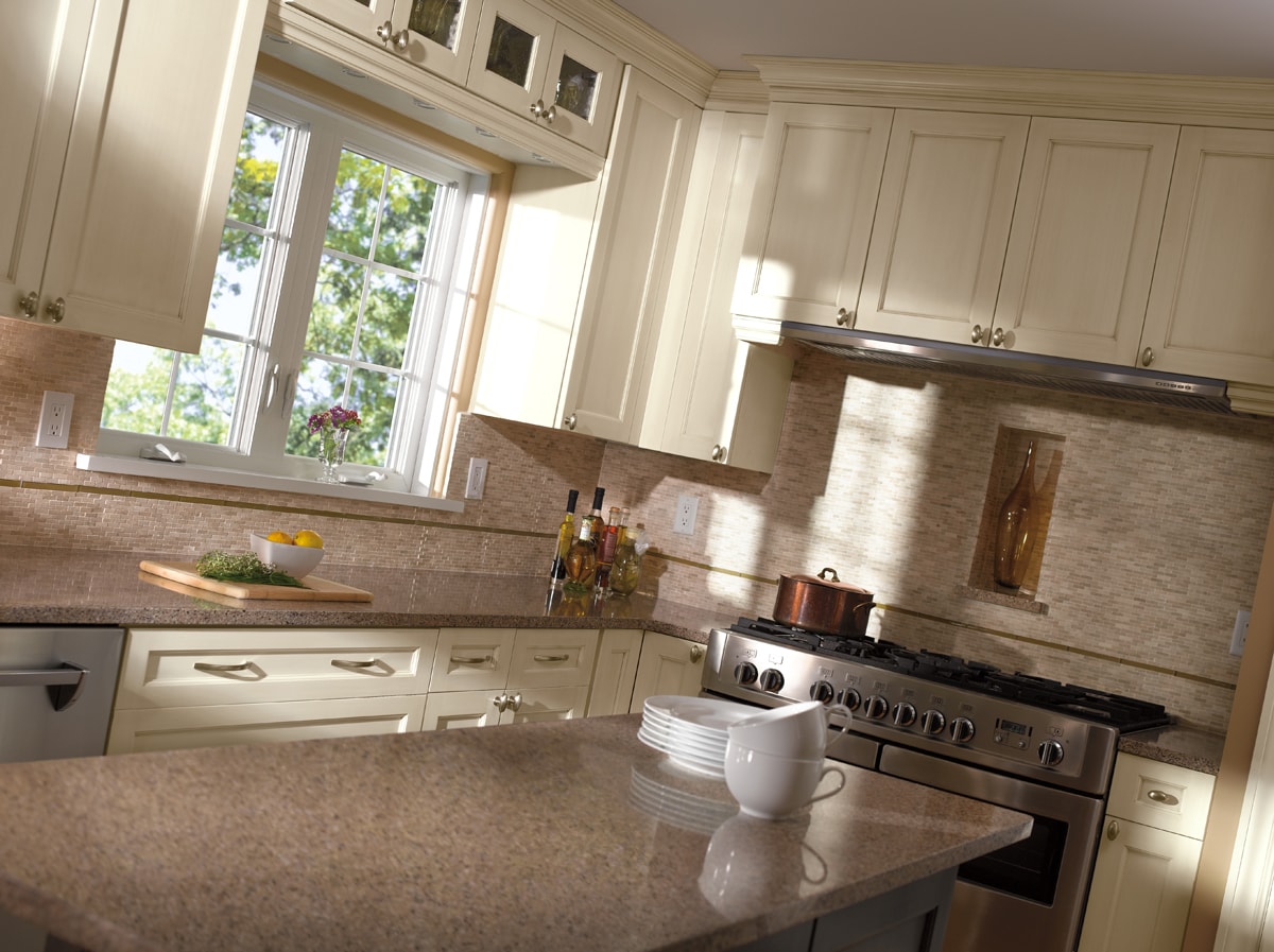 A creamy white kitchen with beige shaker-style cabinetry.