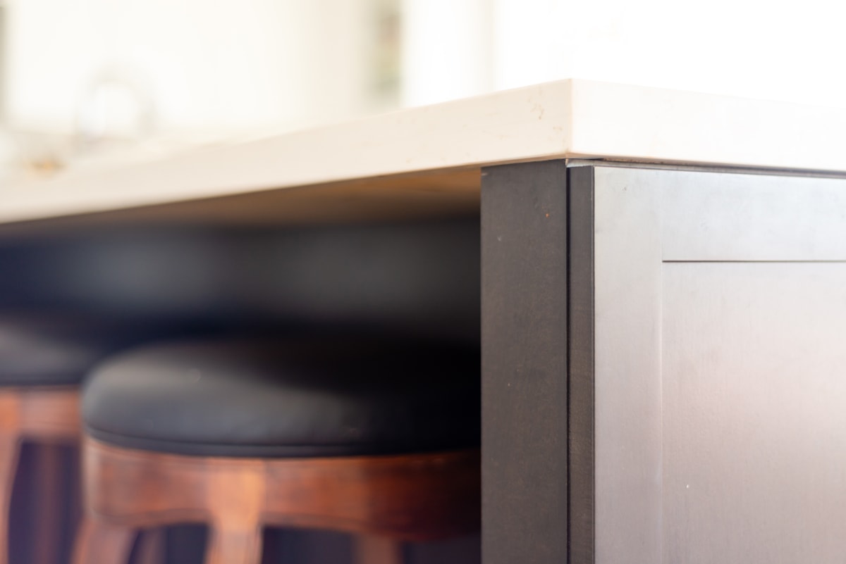 Close up of a kitchen island with bar stools.