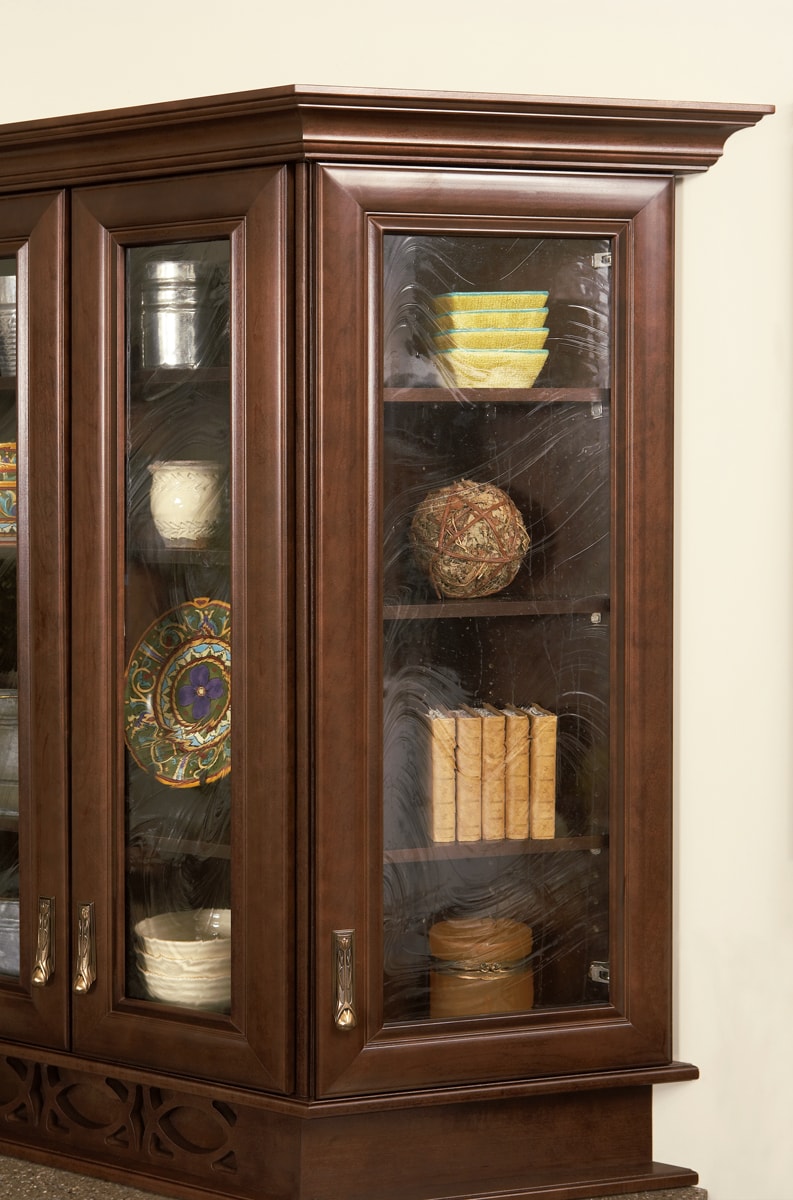 Dark brown china cabinet with crown moulding.