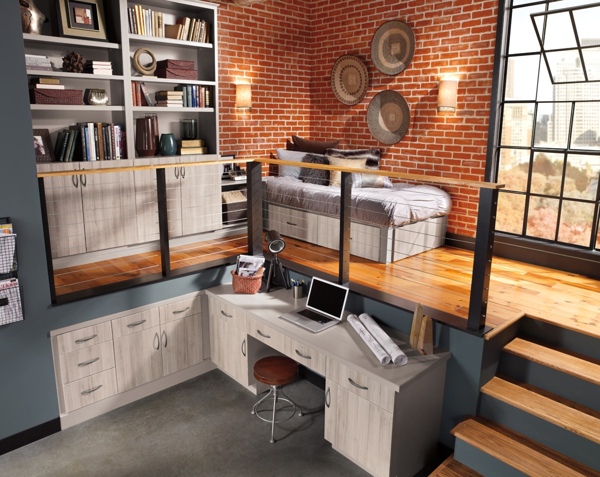 Loft style bedroom with matching grey bookcases, desk and under bed storage.